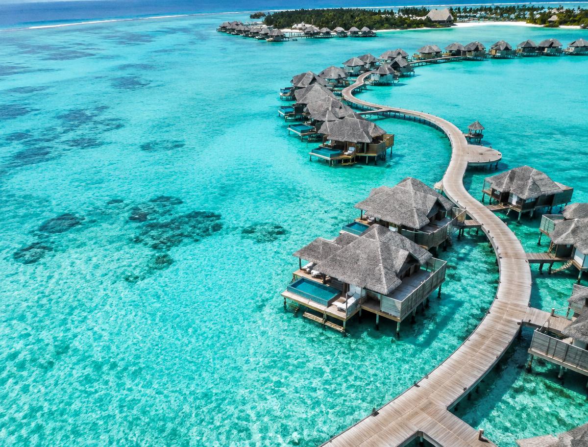 Overwater villas above a turquoise lagoon in the Maldives